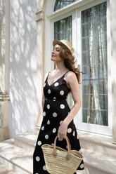 a lady wears a black and white polka dot printed dress